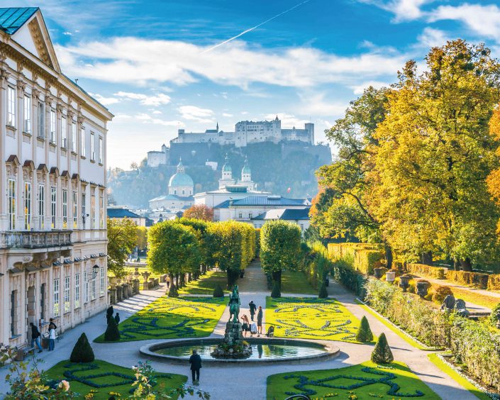 Beautiful view of famous Mirabell Gardens with the old historic Fortress Hohensalzburg in the background in Salzburg